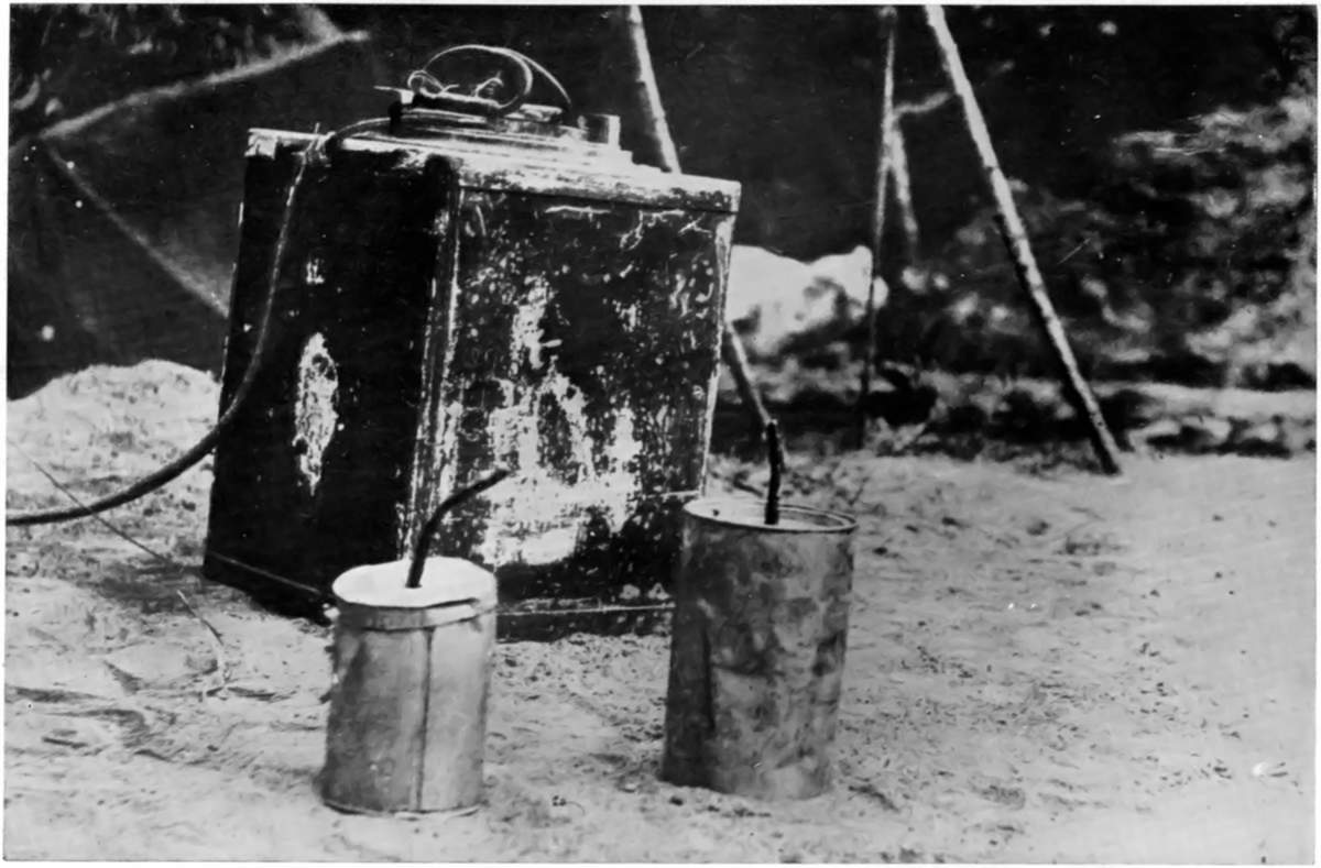 WEAPONS OF GREY "MOLES," AT TSING-TAU: A LAND-MINE AND
EMERGENCY HAND-GRENADES CAPTURED FROM THE GERMANS.